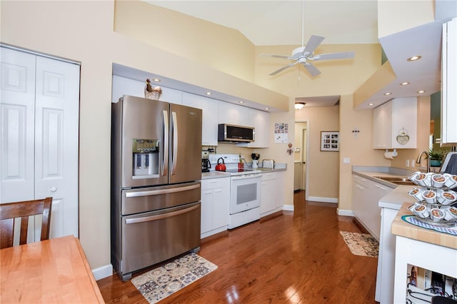 kitchen with stainless steel appliances, a sink, light countertops, white cabinetry, and ceiling fan