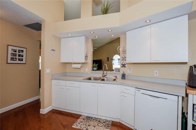 kitchen featuring dishwasher, a sink, dark wood-style flooring, light countertops, and recessed lighting