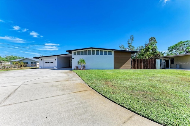 ranch-style home featuring a carport and a front yard