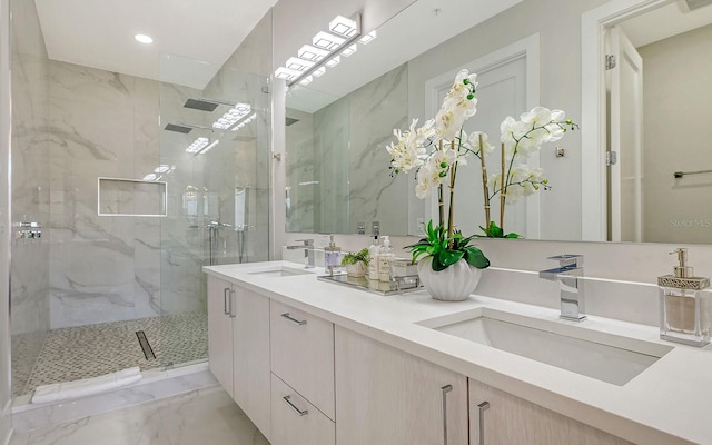 bathroom featuring tiled shower and vanity