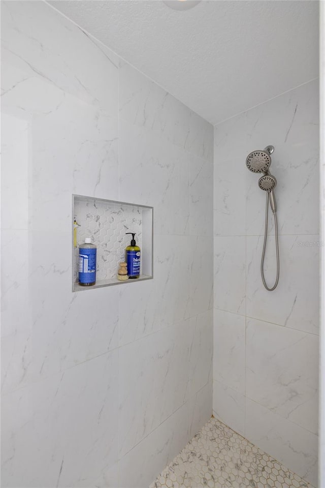 bathroom with tiled shower