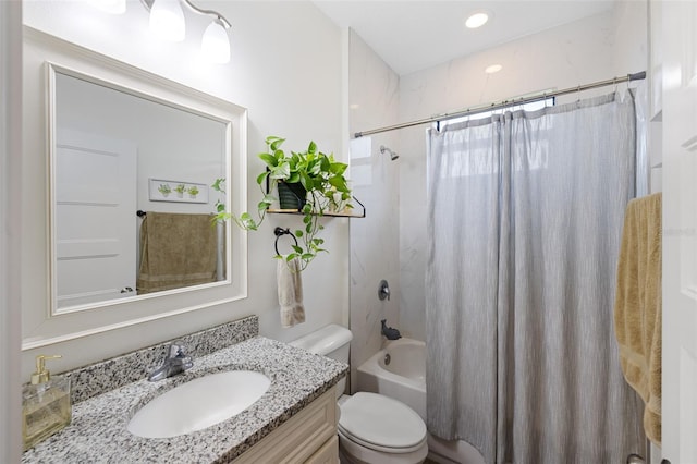 full bathroom featuring shower / bath combo, vanity, and toilet