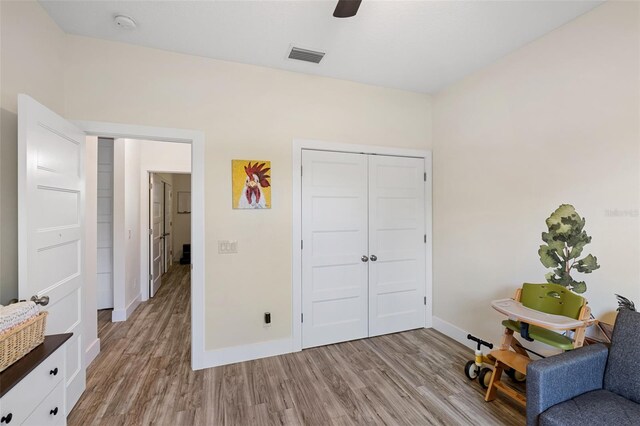 living area featuring ceiling fan and light wood-type flooring