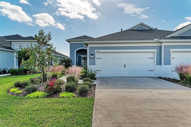 view of front of home featuring a garage and a front yard