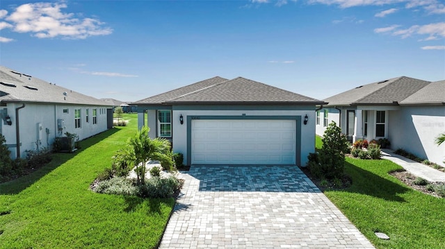 single story home with a garage, a front yard, and central AC