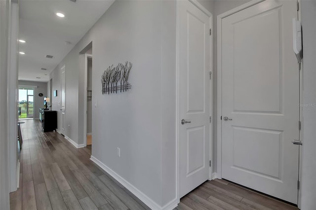 hallway with light hardwood / wood-style floors