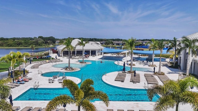 view of pool with a water slide and a water view