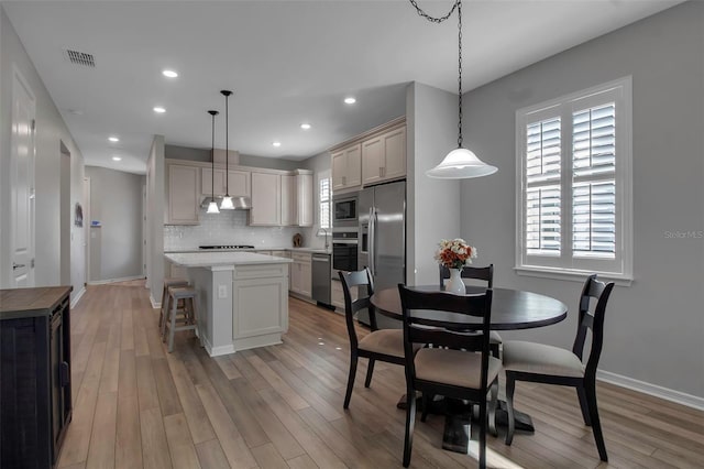 dining room with sink and light hardwood / wood-style flooring