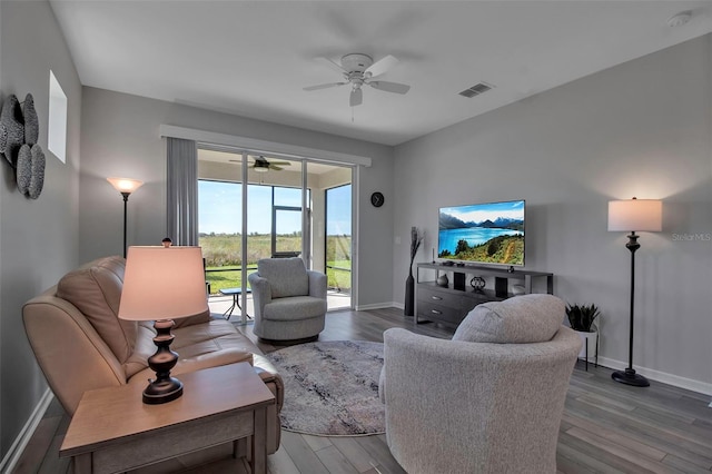 living room with ceiling fan and hardwood / wood-style flooring