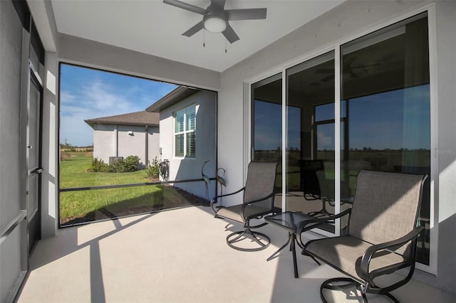 sunroom / solarium featuring ceiling fan