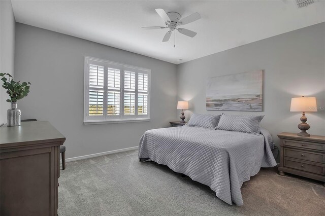 bedroom featuring light carpet and ceiling fan