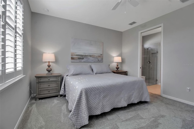 bedroom featuring ceiling fan, ensuite bathroom, and light carpet