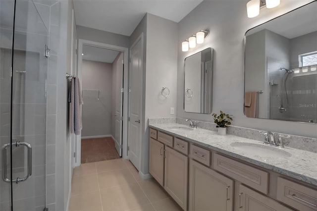 bathroom with tile patterned floors, vanity, and a shower with door