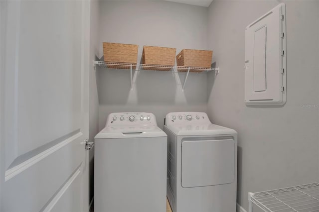 laundry room with separate washer and dryer and electric panel