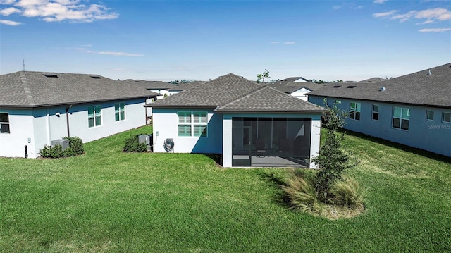 back of house with a sunroom and a yard