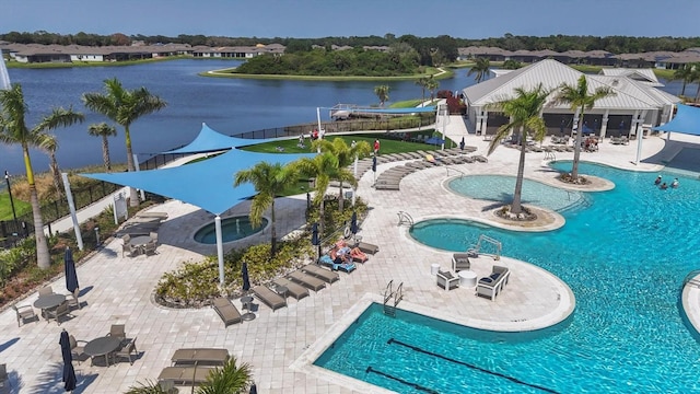 view of pool featuring a water view and a patio