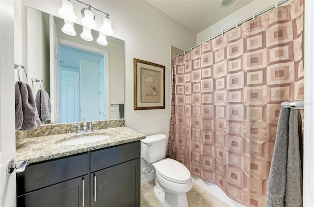 bathroom featuring curtained shower, toilet, vanity, and tile patterned flooring