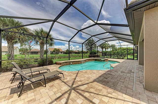 view of pool with an in ground hot tub, a lanai, and a patio