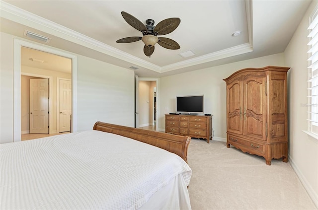 bedroom featuring ceiling fan, light colored carpet, multiple windows, and a tray ceiling