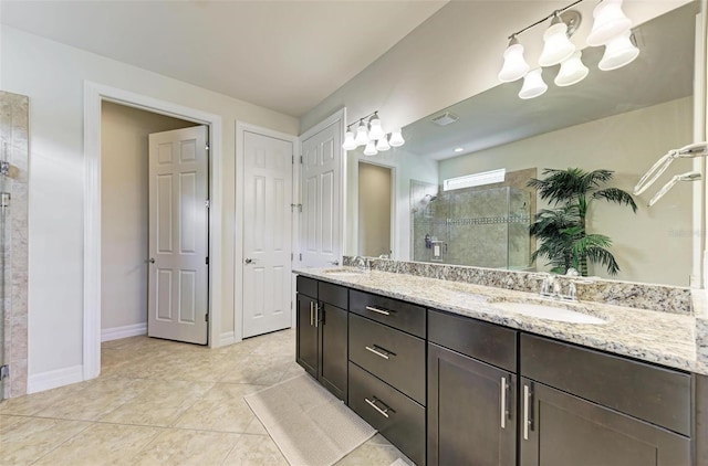 bathroom featuring tile patterned floors, an enclosed shower, and vanity