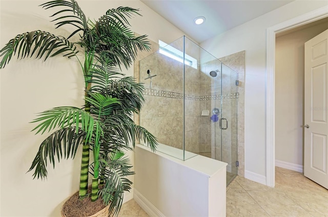 bathroom featuring tile patterned flooring and an enclosed shower