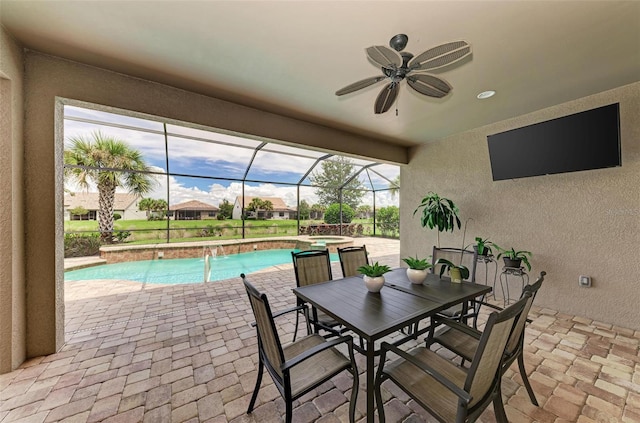 view of patio / terrace featuring ceiling fan and a lanai