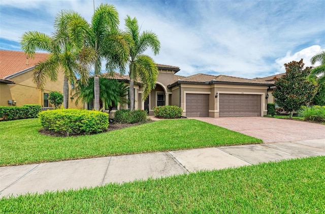 mediterranean / spanish house featuring a front lawn and a garage