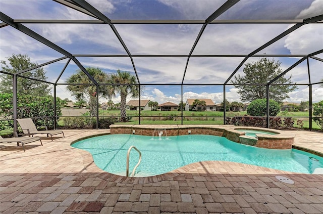 view of swimming pool with a lanai, a patio area, and an in ground hot tub