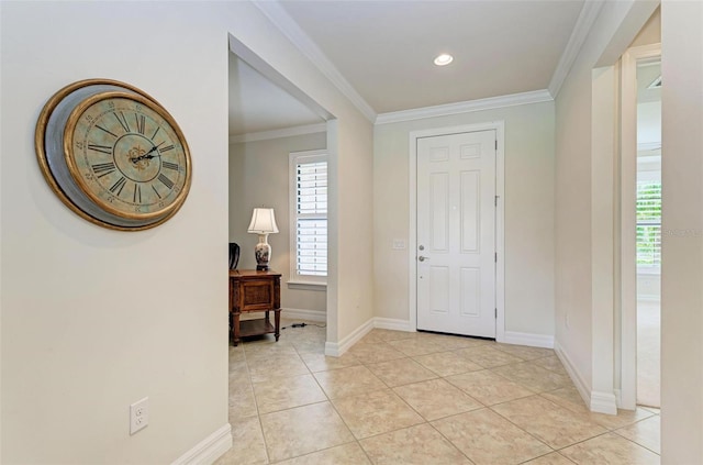 tiled foyer entrance featuring crown molding