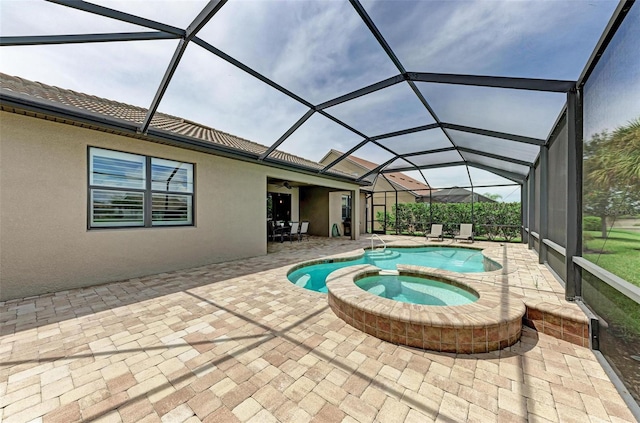 view of swimming pool with a lanai, a patio area, and an in ground hot tub