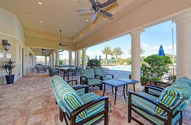 view of patio / terrace featuring a community pool, an outdoor living space, and ceiling fan