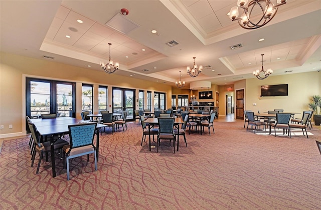 carpeted dining area with a raised ceiling and ornamental molding