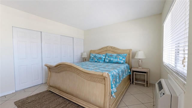 bedroom with a closet and light tile patterned flooring