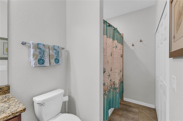 bathroom featuring tile patterned floors, walk in shower, vanity, and toilet