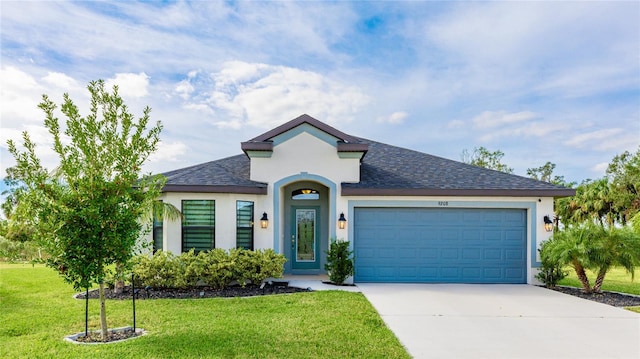 view of front of property featuring a garage and a front lawn