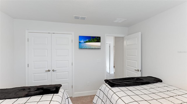 carpeted bedroom with a closet