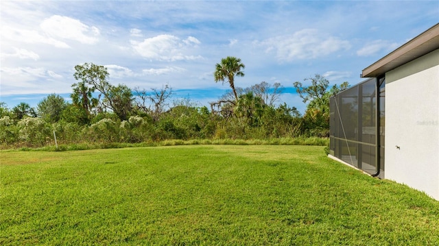 view of yard with glass enclosure