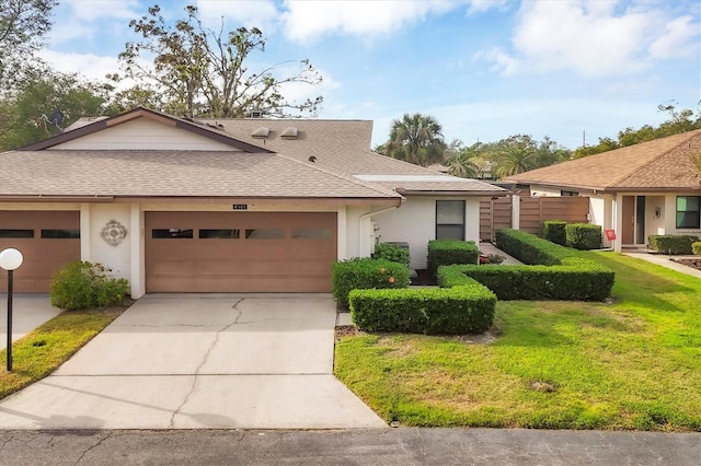 ranch-style house with a garage and a front yard