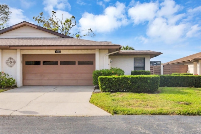 view of front of property featuring a front lawn and a garage