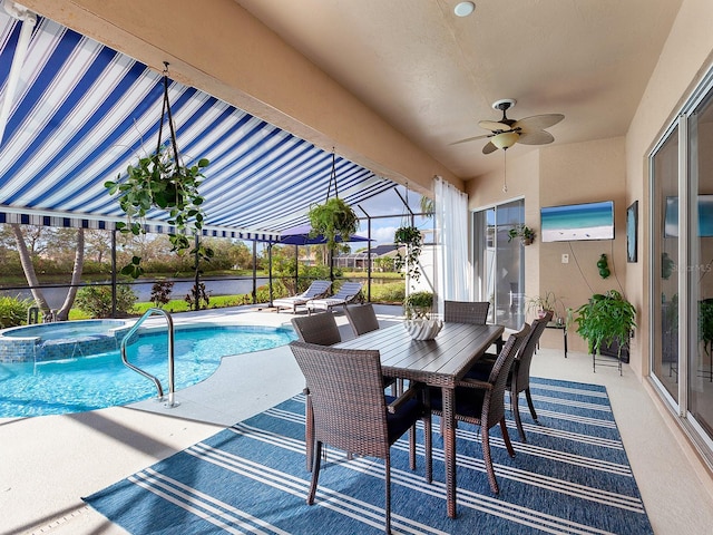 view of swimming pool featuring ceiling fan, a patio area, and an in ground hot tub