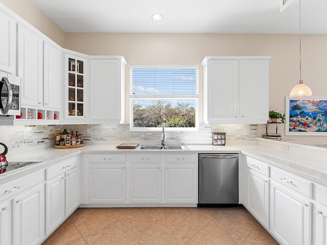 kitchen with white cabinets, appliances with stainless steel finishes, pendant lighting, and sink