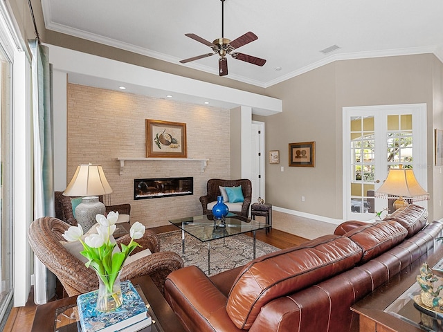 living room with hardwood / wood-style flooring, ceiling fan, and ornamental molding