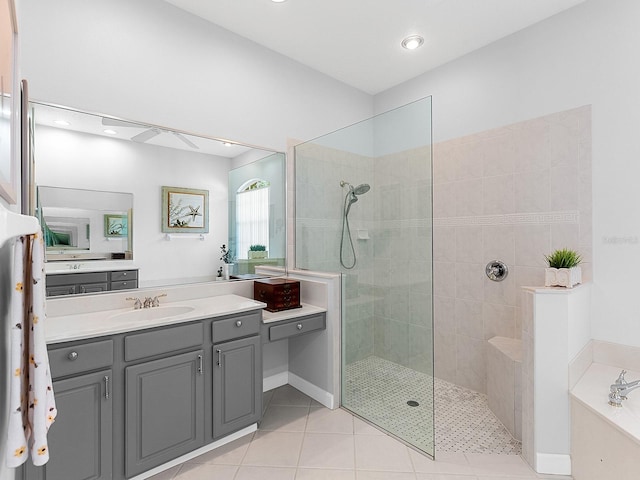 bathroom with shower with separate bathtub, vanity, and tile patterned floors