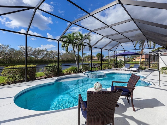 view of swimming pool with an in ground hot tub, a water view, glass enclosure, and a patio area