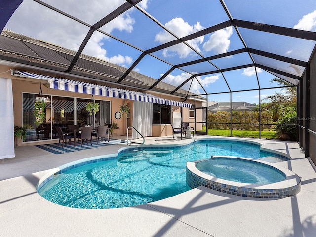 view of pool with a lanai, an in ground hot tub, and a patio