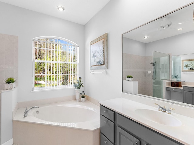 bathroom featuring plus walk in shower and vanity