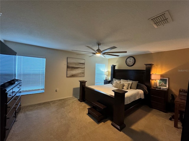 bedroom with carpet flooring, a textured ceiling, and ceiling fan