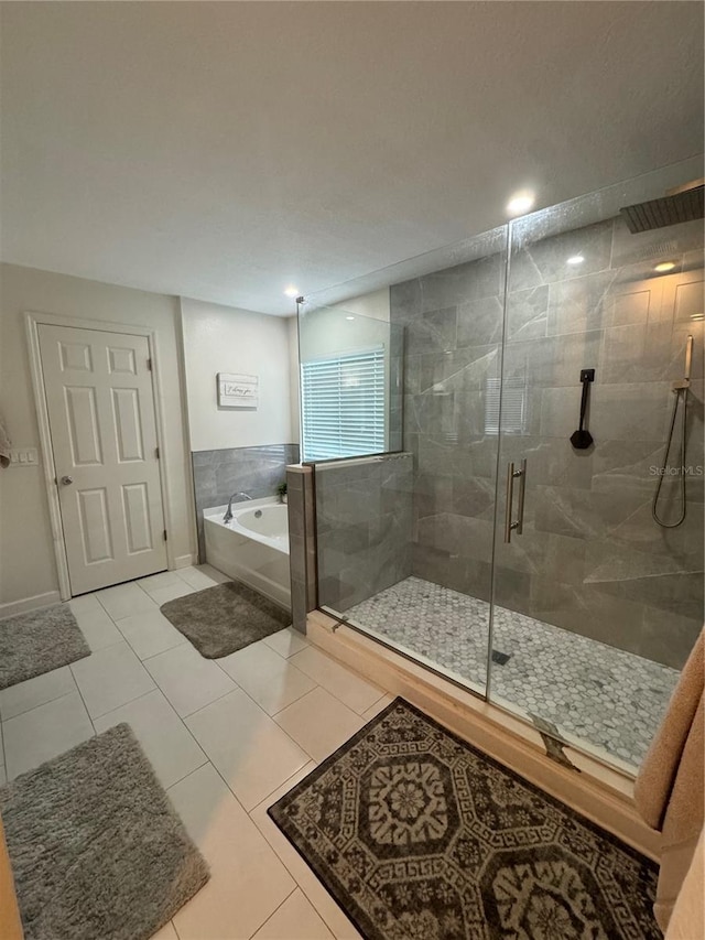 bathroom with tile patterned flooring and independent shower and bath