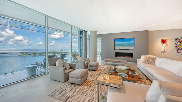 living room featuring a water view and expansive windows