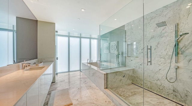 bathroom featuring vanity, expansive windows, and an enclosed shower